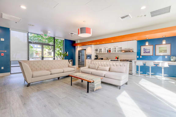 A living room with a white couch and a wooden coffee table.