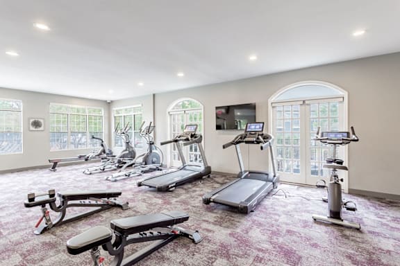 A spacious gym with a variety of exercise equipment.