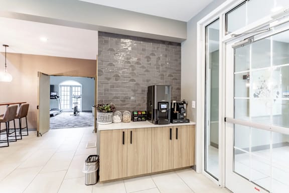 A modern kitchen with a glass door leading to a dining area.