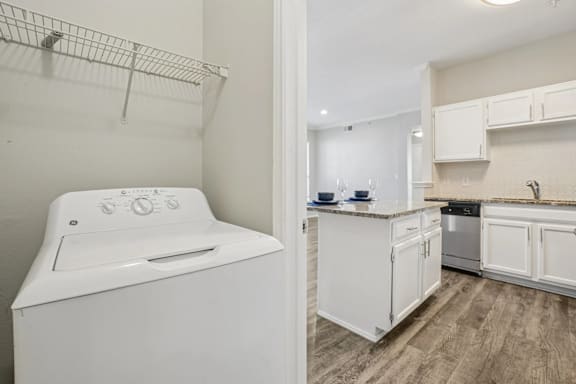 A white washing machine in a laundry room.