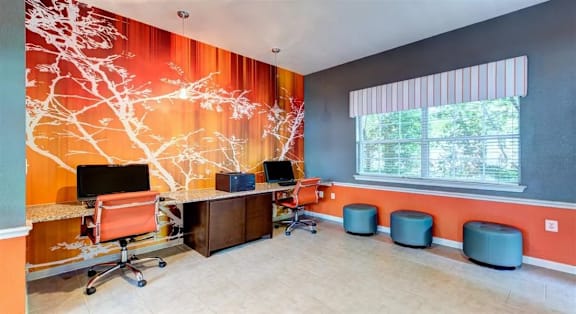 A room with orange walls and a tree mural.