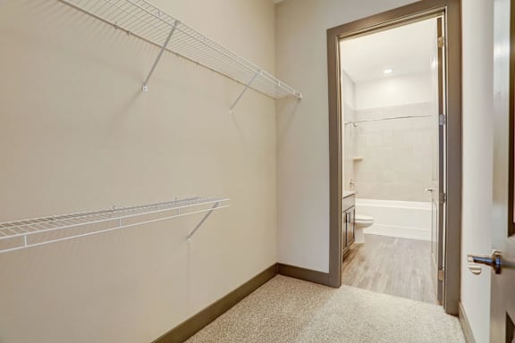 A room with a white wall and a white carpet.