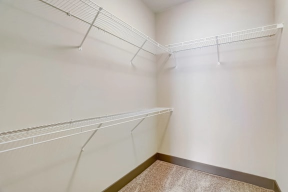 Empty white shelves in a room.