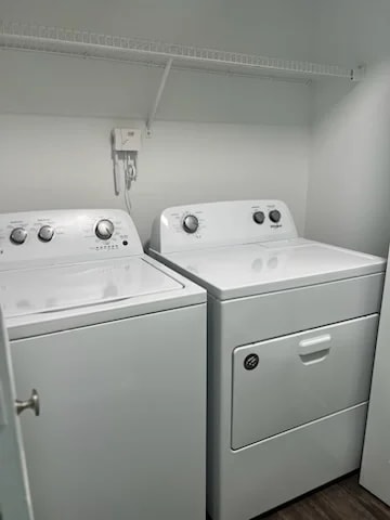 Two white front loading washing machines in a laundry room.