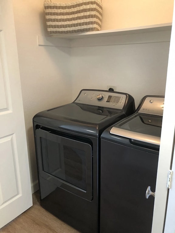 A black microwave oven is placed above a black dishwasher.