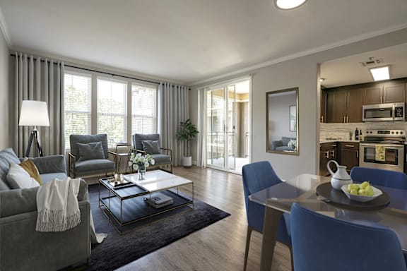 A modern living room with a glass coffee table and blue chairs.