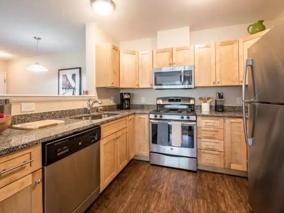 A kitchen with wooden cabinets and stainless steel appliances.