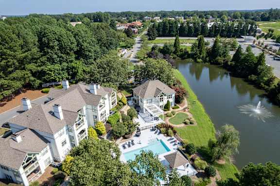 A large white house with a pool in the backyard.