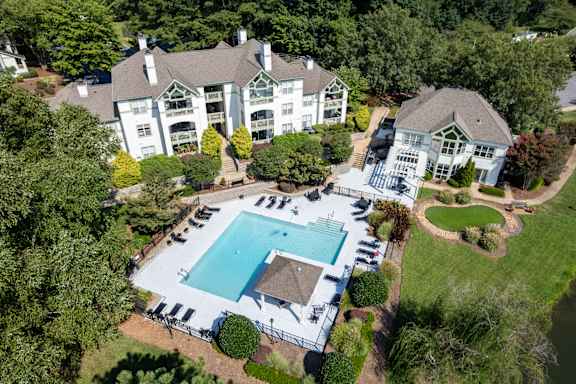 A large white house with a pool in the backyard.