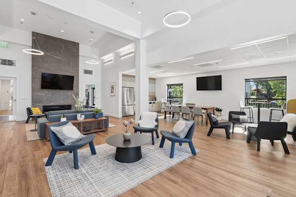 A modern living room with a fireplace and a TV on the wall.