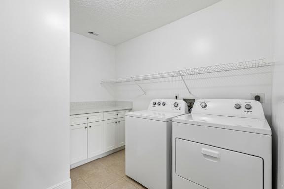 A laundry room with a washer and dryer.