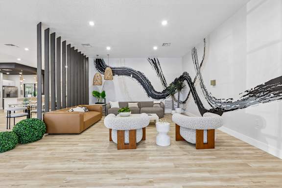 A modern living room with a large sculpture on the wall.