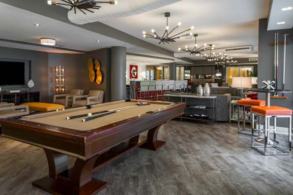 a clubhouse with a pool table and a bar