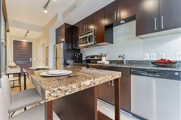 a kitchen with stainless steel appliances and granite counter tops