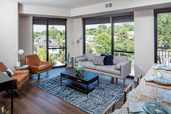 A modern living room with a large window and a view of the neighborhood.