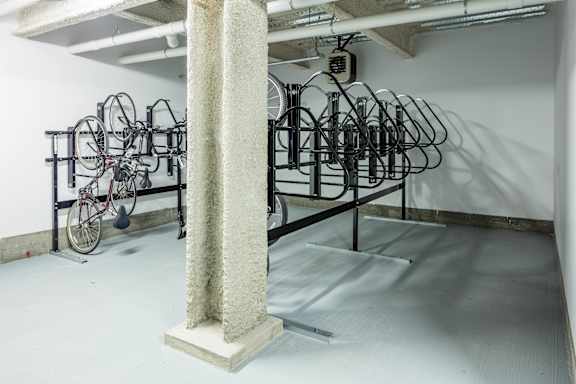 A white room with a column and a bike rack.