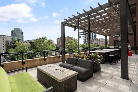 A patio with a table and chairs under a pergola.