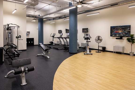 a fitness room with treadmills and other exercise equipment