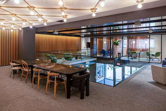 A conference room with a long table and chairs.