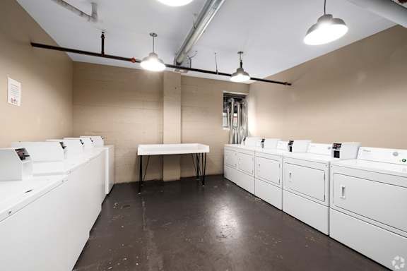 A laundry room with washers and dryers.