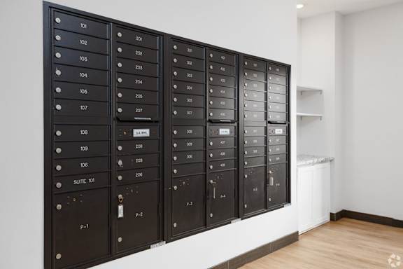 A wall of mailboxes with the numbers 101 to 108 visible.