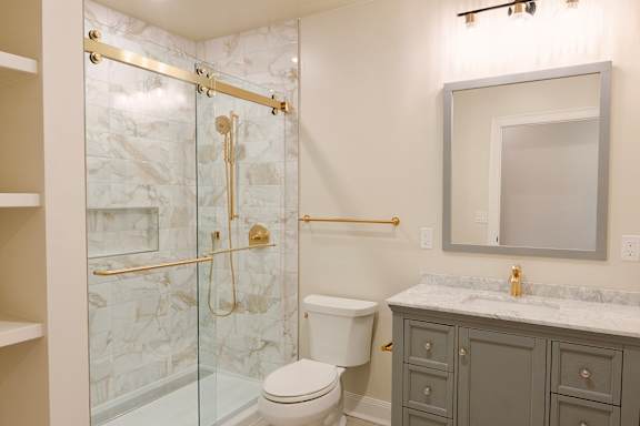 A bathroom with a marble shower and a white toilet.