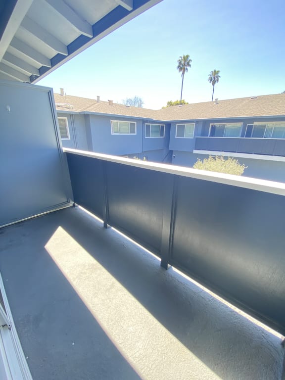 a view of the top of a balcony with a building in the background