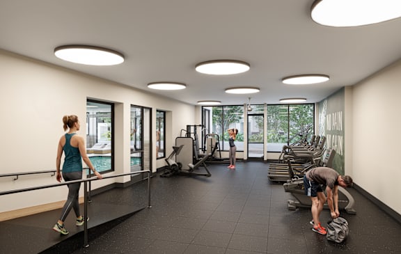 A gym with a woman exercising on a treadmill and another person working out with weights.