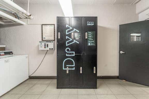 A black door with the word drop written on it.