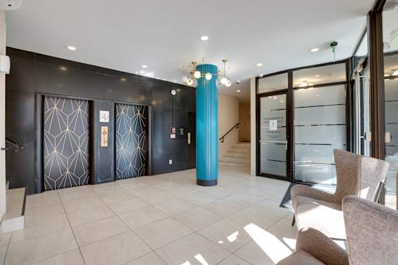 A room with a blue column and glass doors.