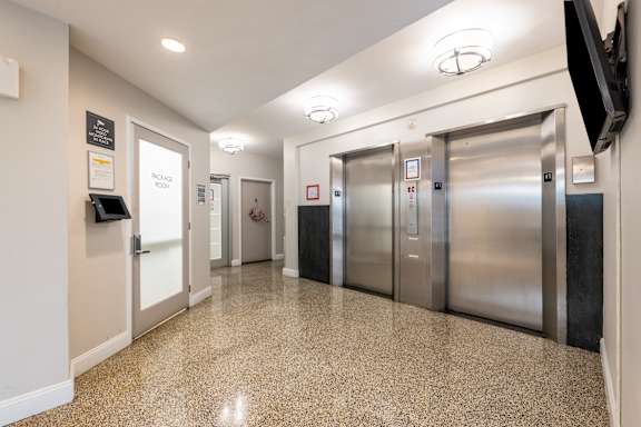 Building hallway with package room and elevator at The Livingston Apartments in Chevy Chase, NW Washington, DC 20015
