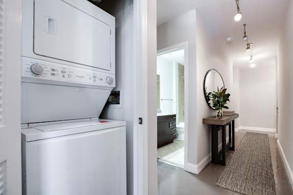 A white oven and dishwasher in a modern kitchen. at Park Place at Petworth, Washington, 20011