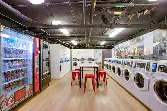 A laundromat with a Coca-Cola vending machine.