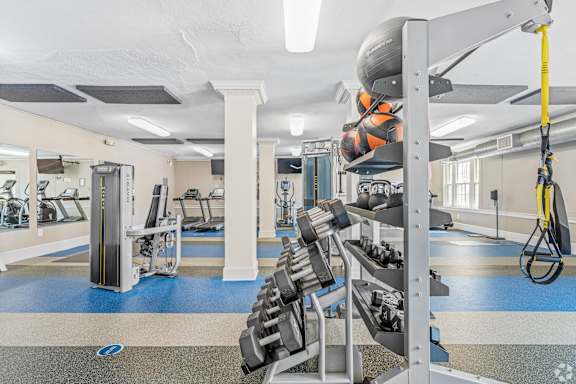 A gym with a variety of equipment including a leg press machine.