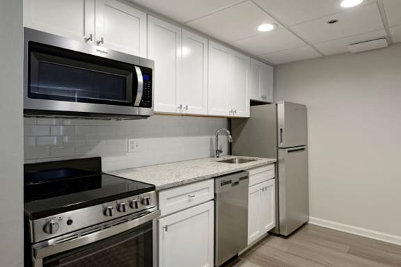 Renovated kitchen with granite countertops and stainless steel appliances  at Lenox Club, Virginia, 22202
