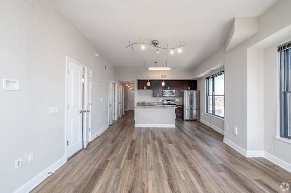 A spacious kitchen with a dining area and a living room with a bar. at Park Place at Petworth, Washington, DC, 20011