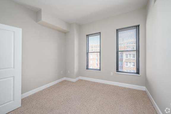 A room with two windows and a carpeted floor. at Park Place at Petworth, Washington, DC, 20011