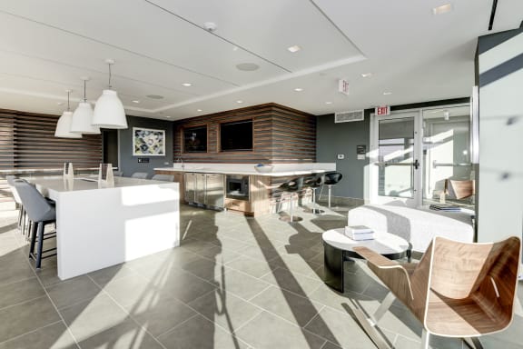 A kitchen and living room with a bar and chairs  at Valo Apartments, Washington