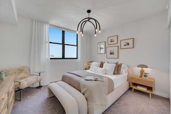 A bedroom with a large bed and a window.