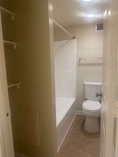 A white toilet in a small bathroom.