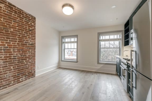 Studio 10 living space with kitchen and exposed brick