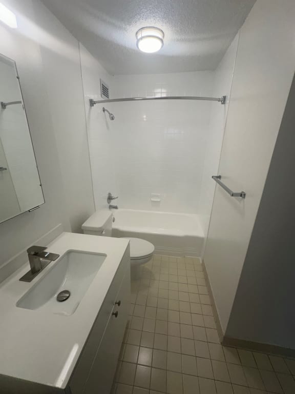an empty bathroom with a sink toilet and shower