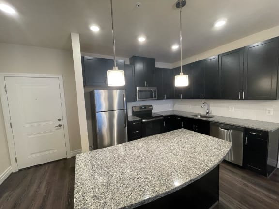 kitchen with dark brown cabinets and a granite counter top