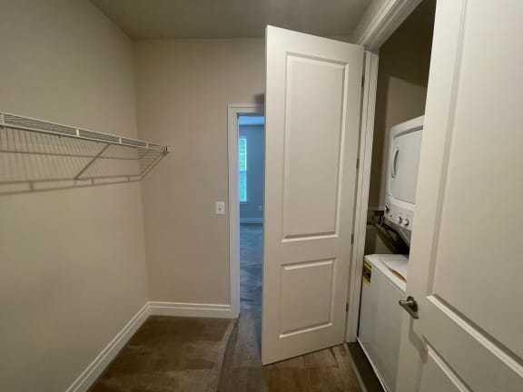 walk through closet with stackable washer and dryer