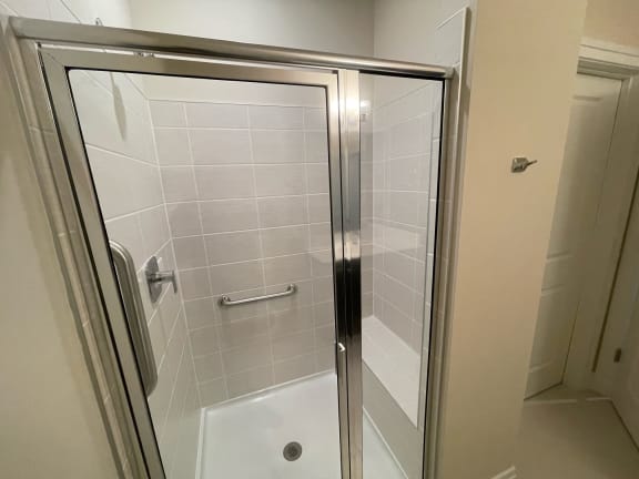 bathroom with a shower, sink and a toilet