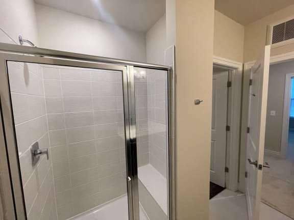 bathroom with a shower, sink and a toilet