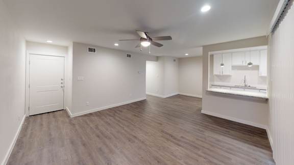 A room with a ceiling fan and lighting fixtures.