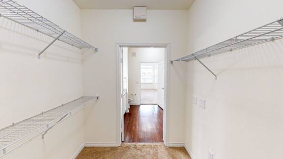 A white room with a doorway leading to another room.