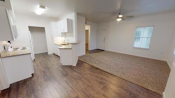 A room with wooden floors and white walls.