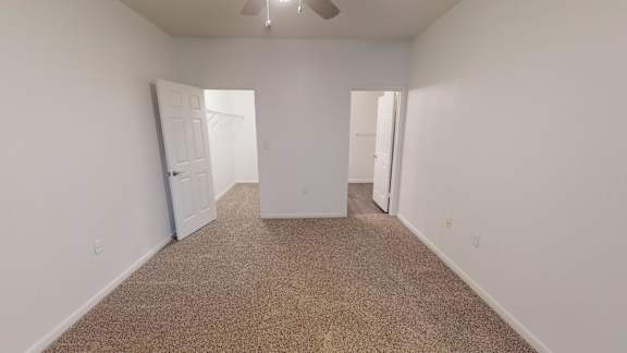 A room with carpeted floor and white walls.